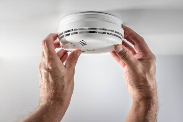 Smoke alarm installer testing alarm functionality in Clapham - SW4 home